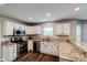 Well-lit kitchen featuring white cabinets, stainless steel appliances, and granite countertops at 416 Concord Way, Greenwood, IN 46142