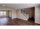 Open-concept living area with staircase, wood floors, and views of the backyard and pond at 416 Concord Way, Greenwood, IN 46142