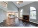 Inviting living room featuring high ceilings, a brick fireplace, and wood-look flooring at 416 Concord Way, Greenwood, IN 46142