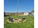 Backyard with firepit, outdoor seating, and a storage shed under a clear blue sky at 422 Hege Ave, Columbus, IN 47201