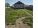 Large backyard featuring green lawn, mature trees, and an outdoor seating area at 422 Hege Ave, Columbus, IN 47201
