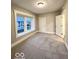Bedroom showcasing carpet flooring, large window, and a neutral color palette at 422 Hege Ave, Columbus, IN 47201