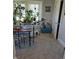 Cozy dining room with a wooden table, upholstered chairs, carpet flooring, and large window with plants at 422 Hege Ave, Columbus, IN 47201