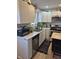 Bright kitchen showcasing white cabinets, stainless steel appliances, marble countertops, and decorative plants at 422 Hege Ave, Columbus, IN 47201