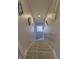 Carpeted stairway with gray walls, white trim, and a handrail at 422 Hege Ave, Columbus, IN 47201