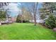 Manicured backyard with a lush lawn and mature trees providing shade and privacy for outdoor enjoyment at 4281 Honeysuckle Ln, Zionsville, IN 46077