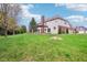 Spacious backyard with a well-manicured lawn, a pergola-covered patio, and mature trees offering shade at 4281 Honeysuckle Ln, Zionsville, IN 46077