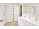 Bathroom featuring double sinks, a large mirror, tile flooring and white cabinets at 4281 Honeysuckle Ln, Zionsville, IN 46077