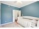 Bedroom with blue walls, white trim and neutral carpet, featuring a doorway to another room at 4281 Honeysuckle Ln, Zionsville, IN 46077