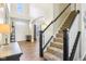 Welcoming foyer with staircase, arched doorway, and hardwood floors at 4281 Honeysuckle Ln, Zionsville, IN 46077