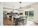 Sun-filled kitchen with a stainless fridge, center island, and sliding doors to the backyard at 4281 Honeysuckle Ln, Zionsville, IN 46077