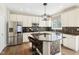 Modern kitchen with stainless steel appliances, granite countertops, and tile backsplash at 4281 Honeysuckle Ln, Zionsville, IN 46077
