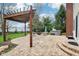 Spacious backyard patio with a pergola, an outdoor fire pit, and a hot tub, perfect for entertaining guests at 4281 Honeysuckle Ln, Zionsville, IN 46077
