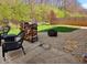 Relaxing patio area featuring outdoor seating, stacked firewood, and a fire pit at 4383 Round Lake Bnd, Indianapolis, IN 46234