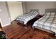 Bedroom with hardwood floors that features two twin beds with matching decor at 4383 Round Lake Bnd, Indianapolis, IN 46234
