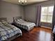Bedroom with hardwood floors that features two twin beds with matching decor at 4383 Round Lake Bnd, Indianapolis, IN 46234