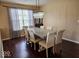 Dining room with chandelier, large windows, hardwood floors, and formal dining table at 4383 Round Lake Bnd, Indianapolis, IN 46234