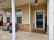 Cozy front porch featuring two comfortable chairs, brick accents, and an inviting entrance at 4383 Round Lake Bnd, Indianapolis, IN 46234