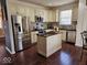 Modern kitchen featuring stainless steel appliances, custom cabinets, and a center island at 4383 Round Lake Bnd, Indianapolis, IN 46234