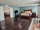 Spacious bedroom with hardwood floors, natural lighting, and ensuite bathroom at 4383 Round Lake Bnd, Indianapolis, IN 46234