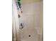 Step-in shower with recessed shelf storage and a shower curtain at 4383 Round Lake Bnd, Indianapolis, IN 46234