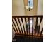 View of the entry through wooden stair railing, showcasing hardwood floors at 4383 Round Lake Bnd, Indianapolis, IN 46234