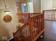 Staircase with a wooden railing leading to the second floor at 4383 Round Lake Bnd, Indianapolis, IN 46234