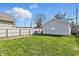 A spacious, green backyard with a white wooden fence, a detached garage, and an open lawn area at 443 N Alton Ave, Indianapolis, IN 46222