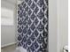Modern bathroom with a stylish black and white patterned shower curtain and window at 443 N Alton Ave, Indianapolis, IN 46222