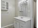 Bathroom featuring a white sink vanity with storage, large mirror, and medicine cabinet at 443 N Alton Ave, Indianapolis, IN 46222