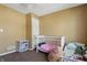 Bedroom showcasing a white crib, ceiling fan, and bright neutral colored walls at 443 N Alton Ave, Indianapolis, IN 46222