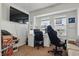 Bright bedroom with a desk, large window, and a modern black gaming chair at 443 N Alton Ave, Indianapolis, IN 46222