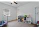 Bright bedroom with neutral walls, ceiling fan and ample space for play and activities at 443 N Alton Ave, Indianapolis, IN 46222
