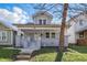 Charming two-story home featuring a covered front porch and manicured lawn at 443 N Alton Ave, Indianapolis, IN 46222