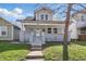 Inviting two-story home with a covered front porch and meticulously kept front lawn at 443 N Alton Ave, Indianapolis, IN 46222