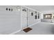 Cozy front porch featuring a modern security door, stylish wall lanterns, and a welcoming doormat at 443 N Alton Ave, Indianapolis, IN 46222