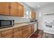 Kitchen with wood cabinets, double basin sink, white appliances, and vinyl flooring at 443 N Alton Ave, Indianapolis, IN 46222