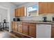 Kitchen boasts wooden cabinetry, laminate countertops, double basin sink, and white appliances at 443 N Alton Ave, Indianapolis, IN 46222