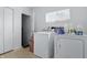 Bright laundry room featuring a white washer and dryer with an open doorway at 443 N Alton Ave, Indianapolis, IN 46222