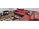 Cozy living room showcasing modern decor, including a plush red sectional sofa and patterned area rug at 443 N Alton Ave, Indianapolis, IN 46222