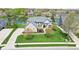 A brick house sits lakeside with lush lawns, an attached garage, and an arched entryway at 476 Sapphire Dr, Carmel, IN 46032