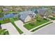 This lakeside brick house has an attached garage, lush lawn, and sidewalk access at 476 Sapphire Dr, Carmel, IN 46032