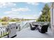 Back deck features seating area with stainless steel BBQ overlooking water at 476 Sapphire Dr, Carmel, IN 46032