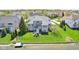 Home features lake access, with a lush lawn and wrought iron fence at 476 Sapphire Dr, Carmel, IN 46032