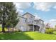 A lovely brick house features a backyard with a wooden deck and stairs to a lush lawn at 476 Sapphire Dr, Carmel, IN 46032