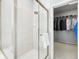 Bathroom showcasing glass shower, tiled walls, and walk-in closet at 476 Sapphire Dr, Carmel, IN 46032