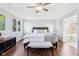 Beautiful bedroom with tray ceiling, hardwood floors, windows and seating at 476 Sapphire Dr, Carmel, IN 46032