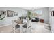 Inviting dining area with tile floors, a ceiling fan, plantation shutters, and a dining table with seating at 476 Sapphire Dr, Carmel, IN 46032