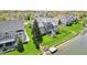 Beautiful two-story home with a large lawn, private dock, and lush landscaping creating a serene atmosphere at 476 Sapphire Dr, Carmel, IN 46032