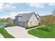 A bright brick house with an attached 3 car garage and a beautifully manicured lawn at 476 Sapphire Dr, Carmel, IN 46032